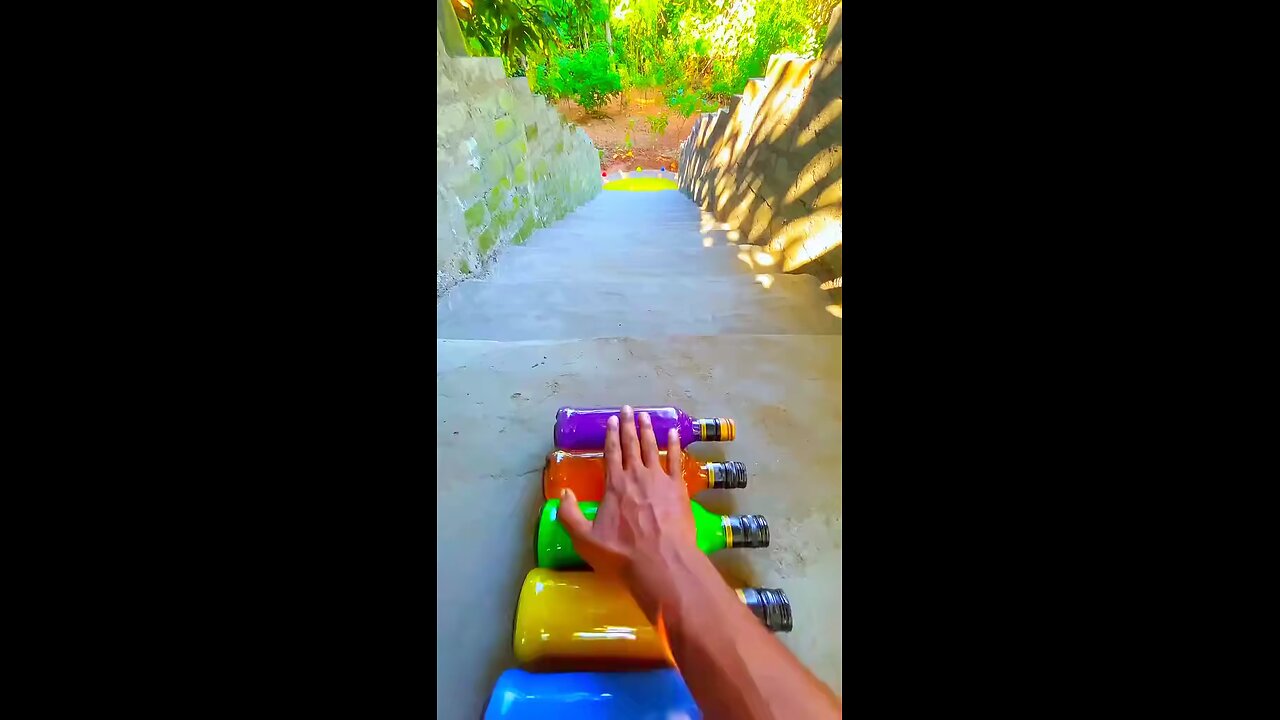 Many bottles of different colours falling from stairs