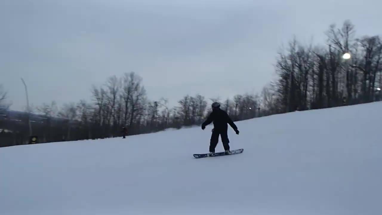 Snowboarding down a hill. I follow behind.