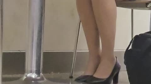 Operation Airhose - crossed ankle shoeplay in food court
