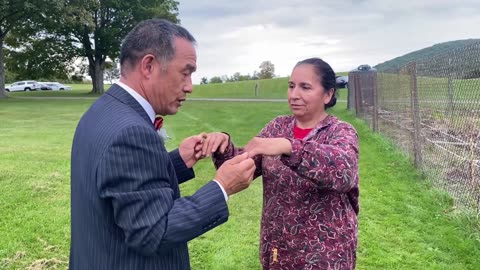 Luodong Chi Checks Elderly Hispanic Woman While Wearing A Tuxedo