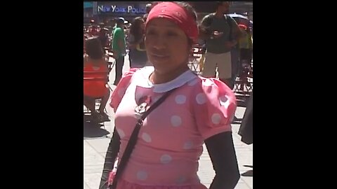 Luodong Massages Woman In Pink Polkadot Dress In Times Square