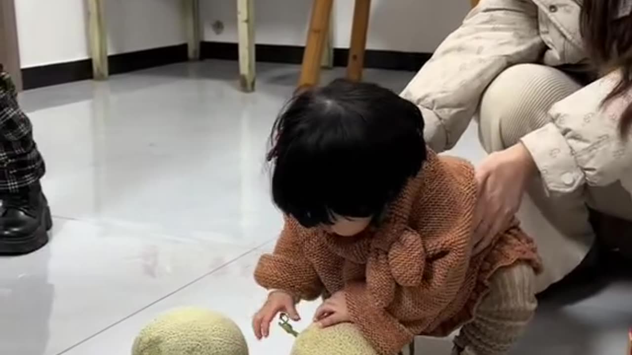 cute baby is picking sweet fruit