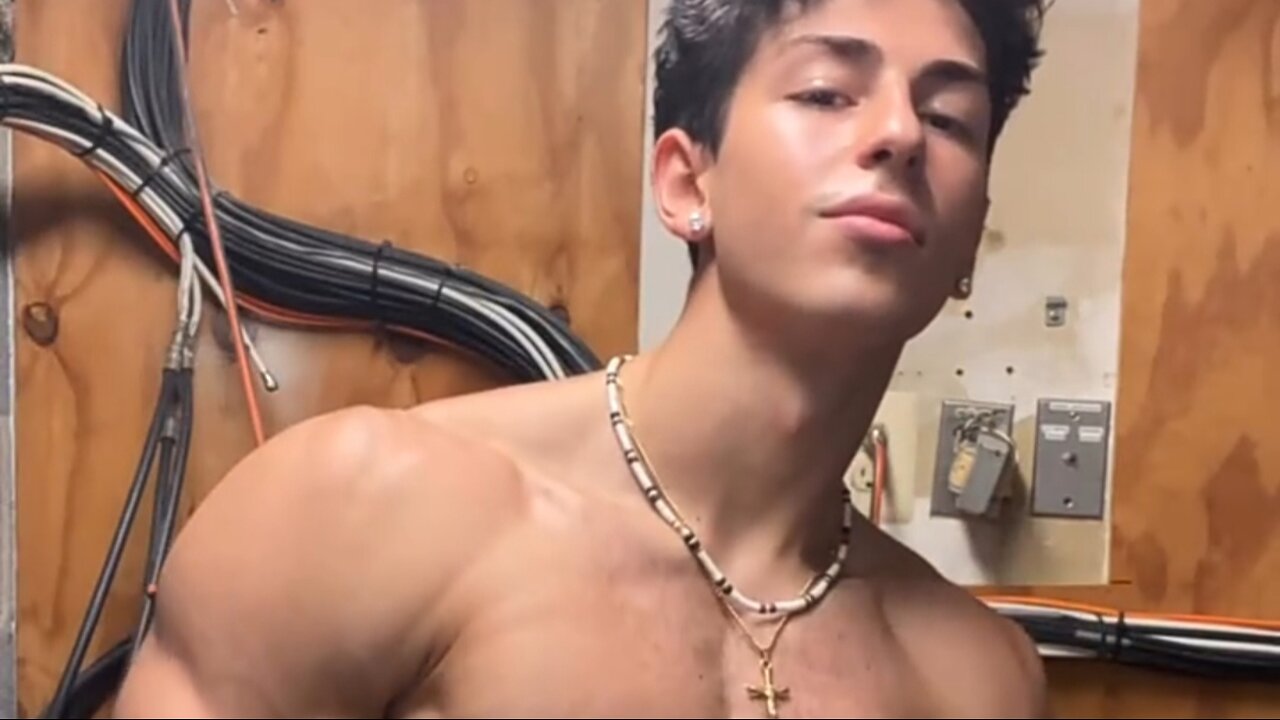 Young aesthetic bodybuilder flexing muscles