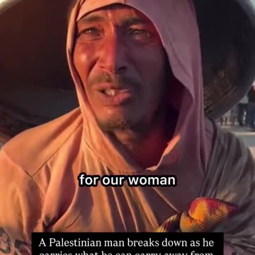 A Palestinian man breaks down as he carries what he can carry away from his home