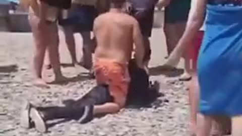 Spanish beachgoers try to stop African invaders making beach landings