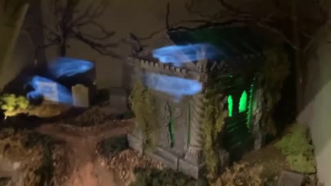 A cemetery diorama where miniature spirits were created using the "Pepper's Ghost" illusion technique