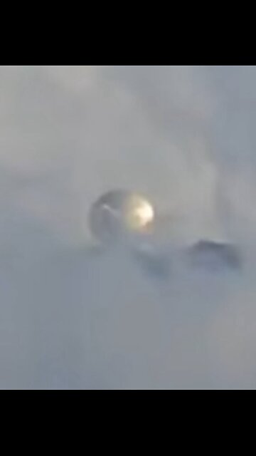 An enormous metallic UFO sphere was observed hovering above a volcano in Mexico.