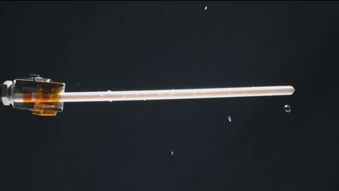 WATER DROPLET ORBITS A KNITTING NEEDLE IN ZERO GRAVITY