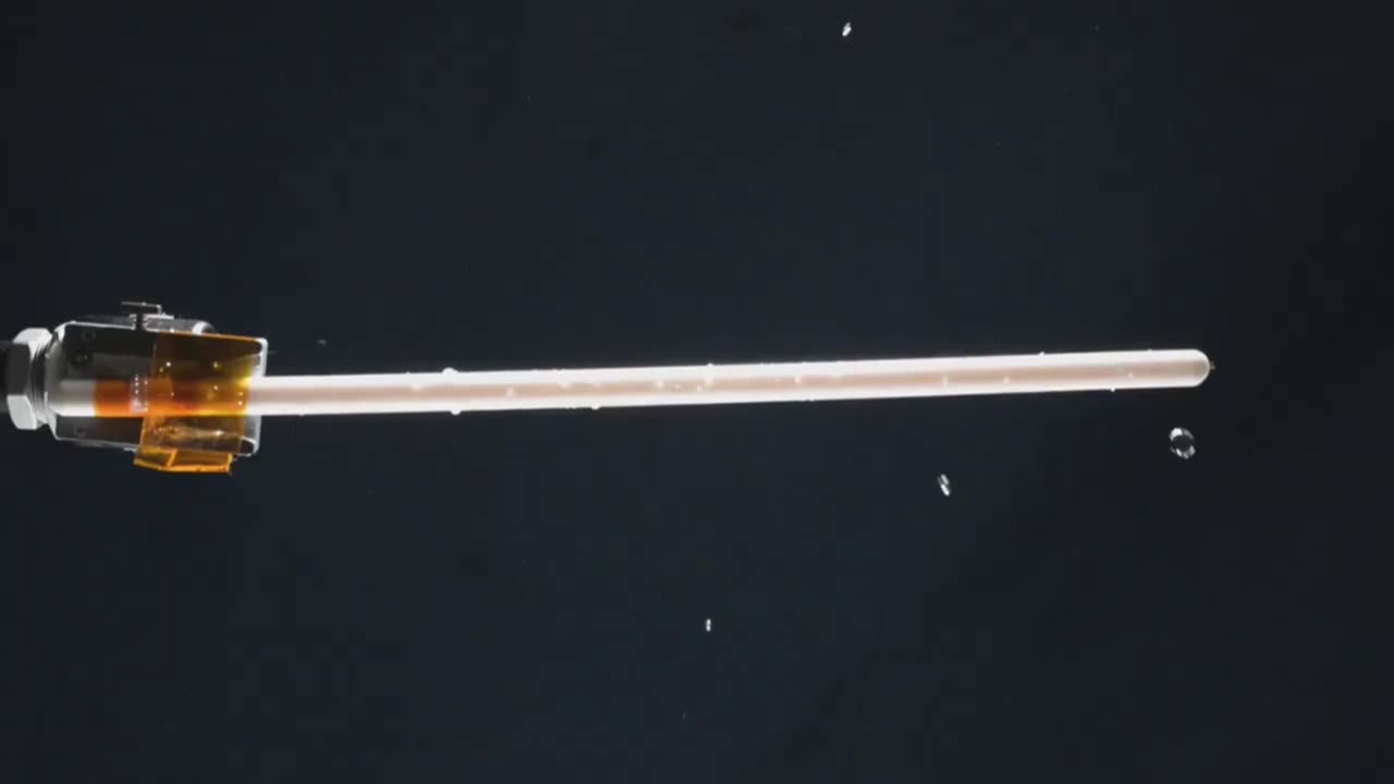 WATER DROPLET ORBITS A KNITTING NEEDLE IN ZERO GRAVITY