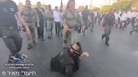 A Haredi protester opposing the IOF draft law was seen being stomped on by an Israeli cop