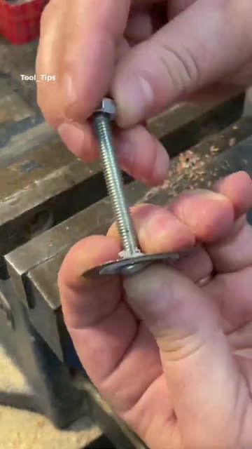 Electric Drill with Grinding Disk Sharpening Metal in a Workbench Vise