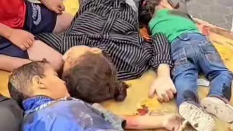 A Palestinian child bids farewell to his mother and siblings, martyred after a Zionist bombing