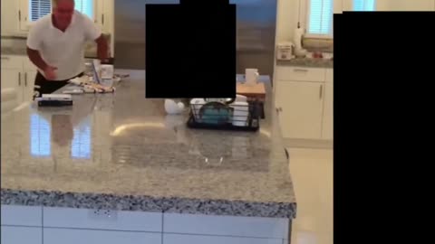 A disturbing video of Jeffrey Epstein chasing young girls around his kitchen