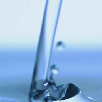 Very close view of a jet falling into a pool of water
