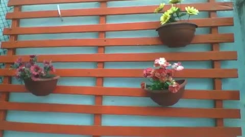 3 vases with plastic flowers hanging on the wood near the wall [Nature & Animals]