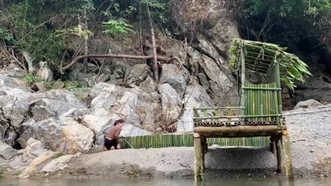 A hard worker lady made shelter for herself on the bench of river