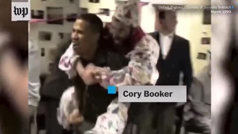 Rabbi Shmuley wearing a clown suit on Senator Cory Booker's back while he was at Oxford in 1993.