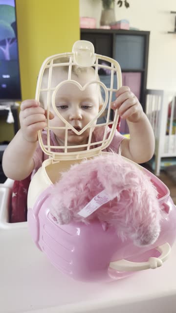 baby kayla playing with toy dog! in the cage you go!