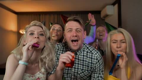 Young people partying with party hats.