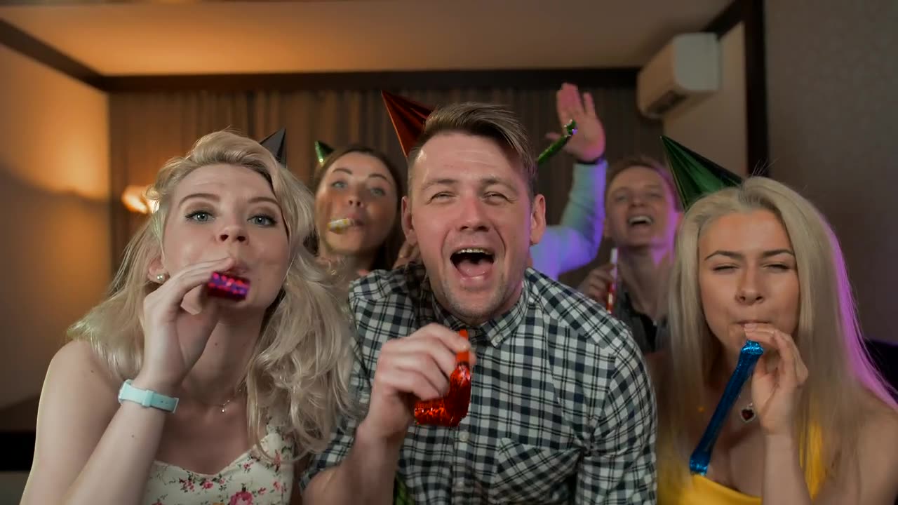Young people partying with party hats.
