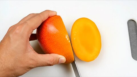 Cutting a mango with a sharp knife