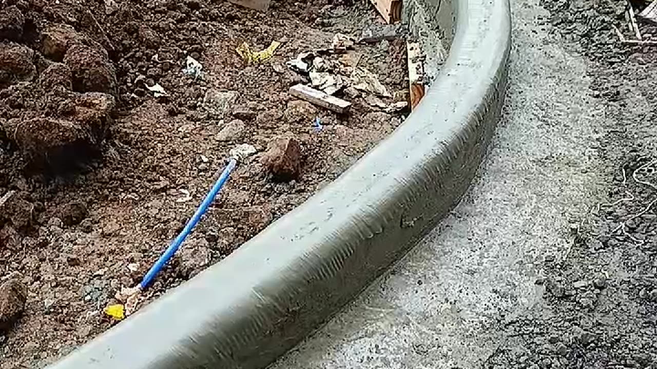 Workers Smooth Concrete With Wet Plastic