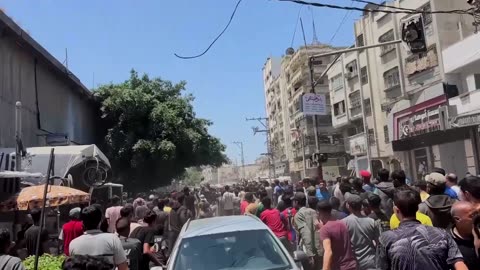 Palestinians run for food as aid trucks arrive in Gaza City