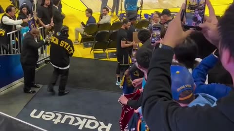 Stephen Curry Makes a One-Handed Shot from the Tunnel