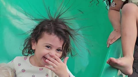 Girl Has Hair-Raising Fun on Slide