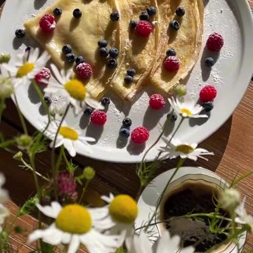 The pancakes are made with milk and served with fresh berries.