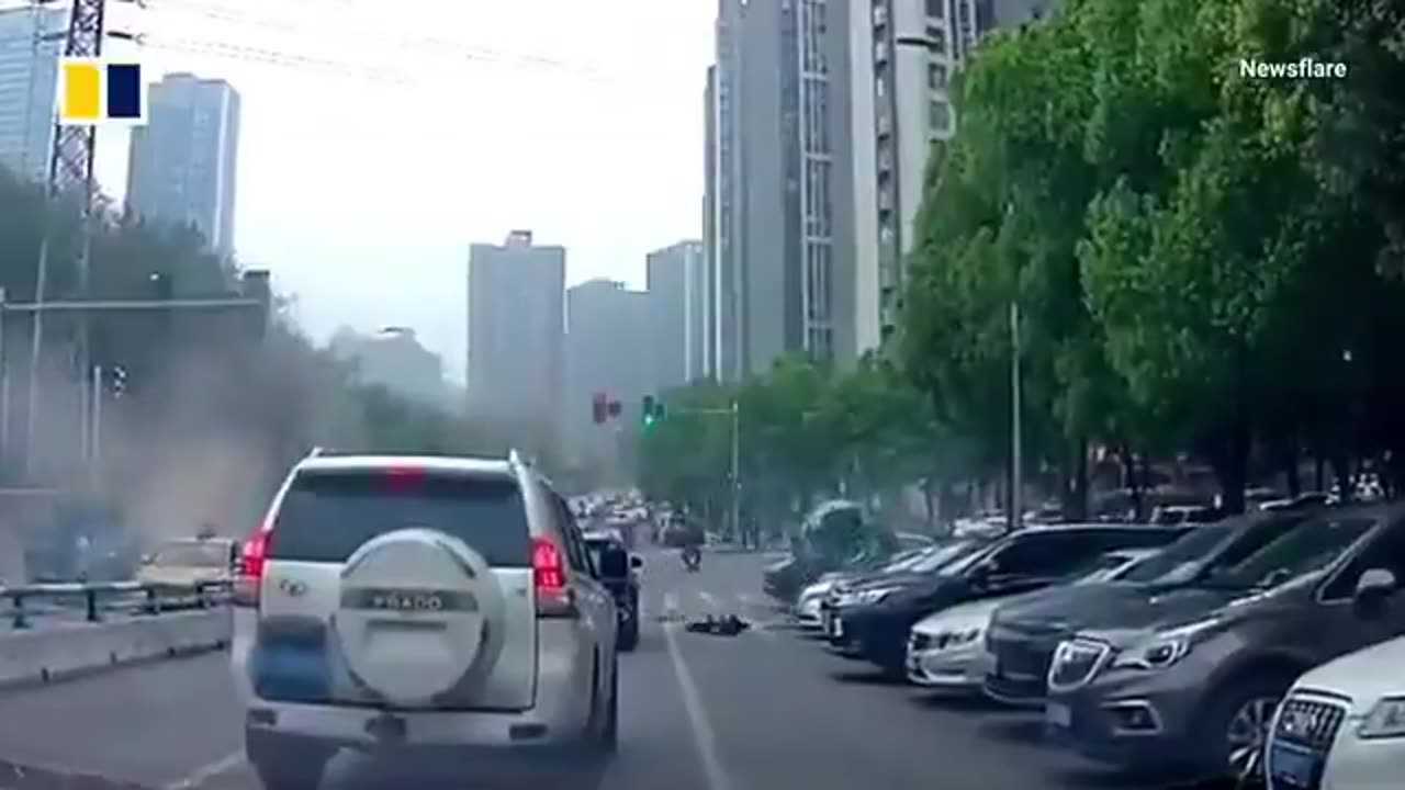 Chinese driver survives after her Tesla is sent flying, landing on parked cars.