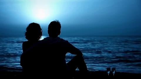 Couple hang out at the beach in the night