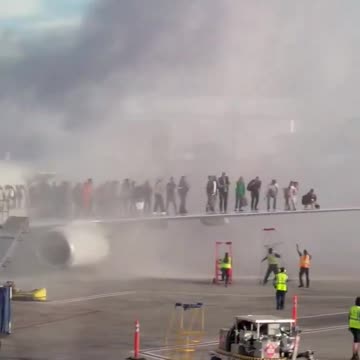 This video shows passengers evacuating the burning plane at Denver International Airport