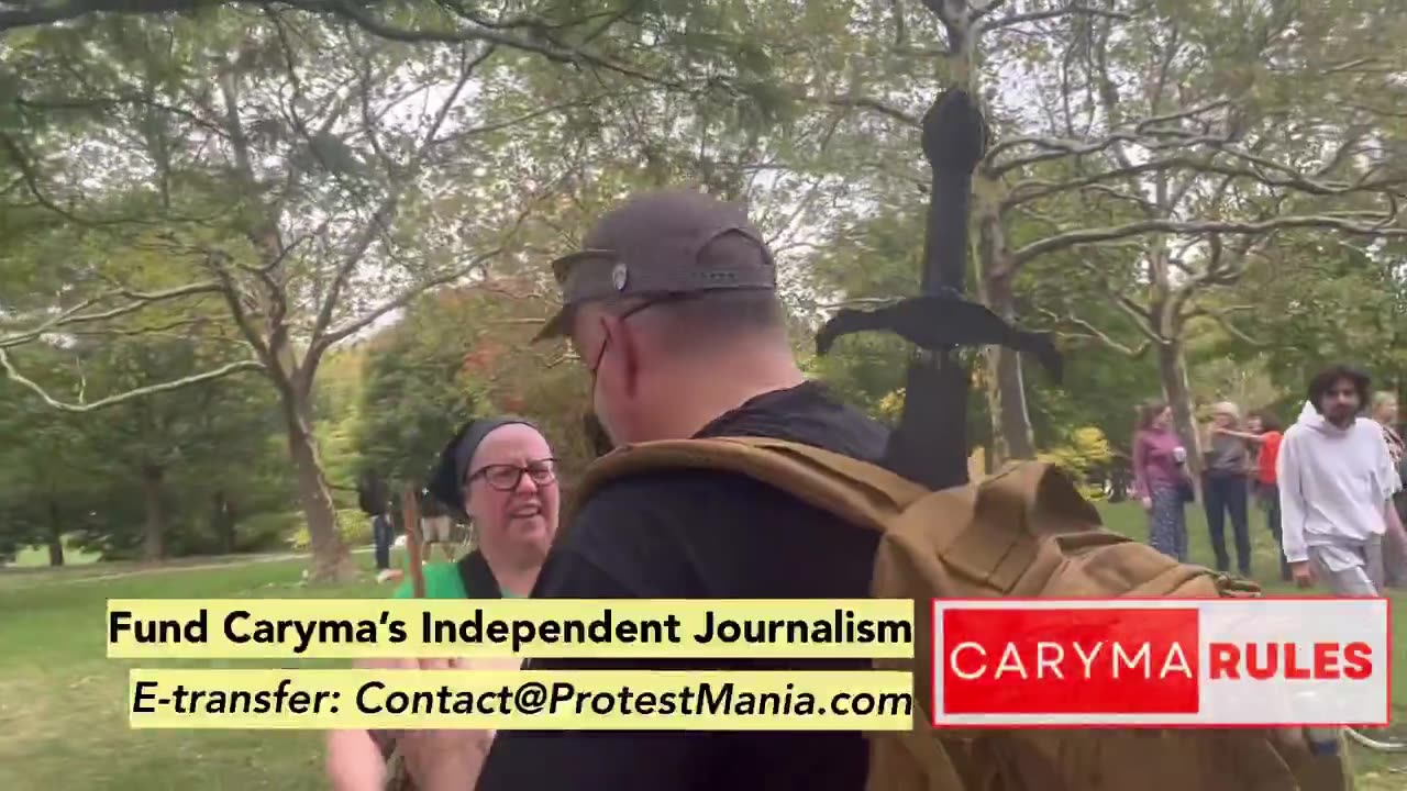 A UNHINGED antifa Karen bangs her drum to drown out a dude signing "All You Need Is Love" in a park