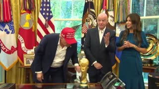 Trump displays a photo from Putin of them together in Alaska and says Putin may