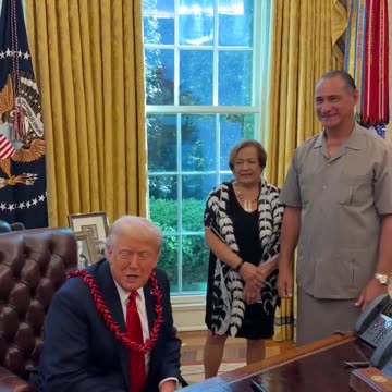 Trump is presented with a Garland that's given to royalty in American Samoa