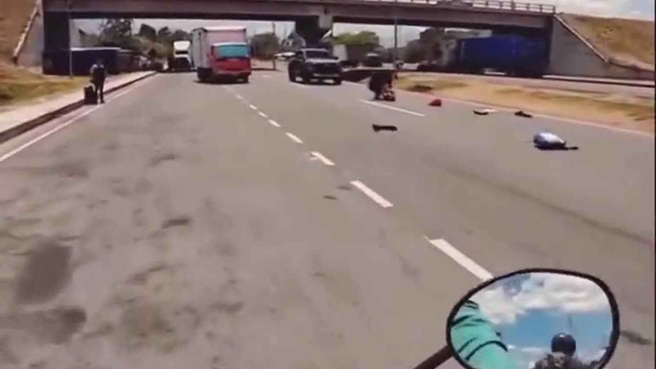 A motorcyclist filmed the moment a woman was crossing the highway.