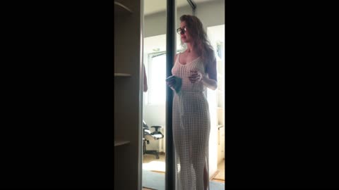 Transparent big mirror cleaning in the room with model girl