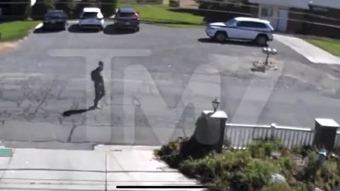 TMZ claims footage of shooter walking to & from the shooting. rifle down pant leg? 