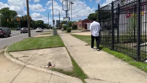 A humanoid robot casually walks down the street in Detroit.