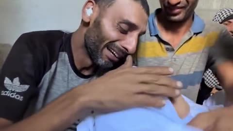 A wounded Palestinian man bids a final farewell to his daughter, Razan