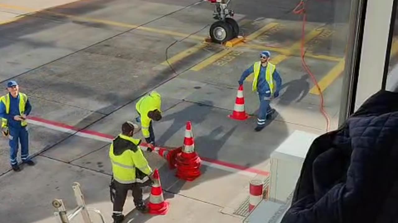 Airport Workers Play With Traffic Cones