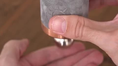A magnet falls slowly through a copper tube due to Lenz’s Law. As it moves, it induces eddy currents