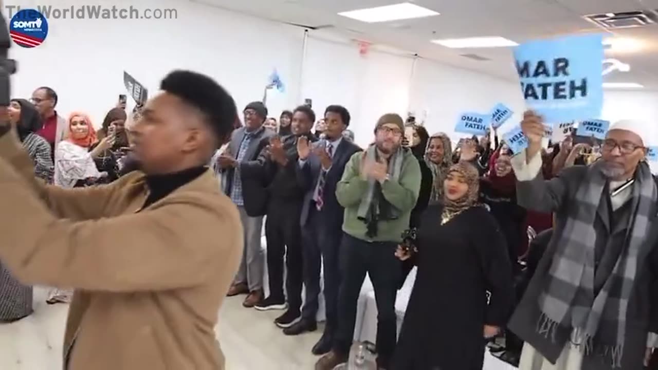 Ilhan Omar campaigning for Omar Fateh in MN. 0 American flags. 0 English.