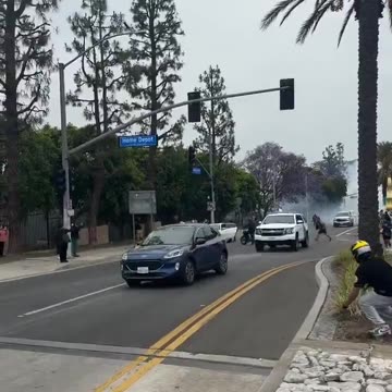 WHY IS THIS GUY NOT BEING ARRESTED??? Man throwing stones at ICE trucks.