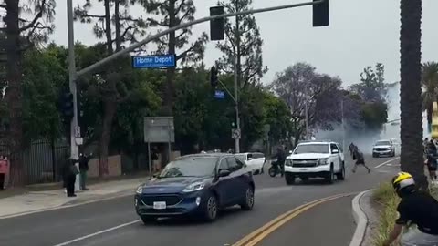 WHY IS THIS GUY NOT BEING ARRESTED??? Man throwing stones at ICE trucks.
