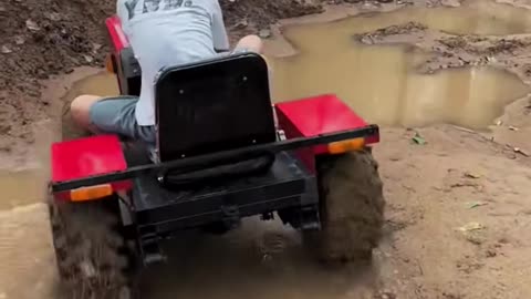 Kids driving mini tractor and playing with tractor