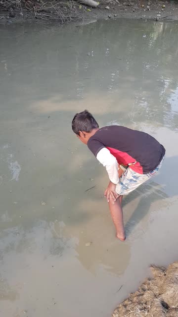 The clever village boy is fishing