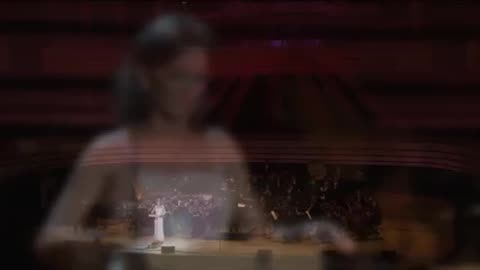 In this orchestra, a woman plays an instrument called a theremin: it is a quantum instrument