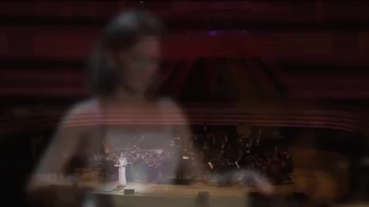 In this orchestra, a woman plays an instrument called a theremin: it is a quantum instrument